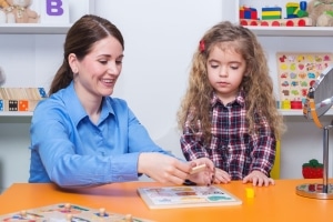 Occupational Therapy Assistant with a young child in a session